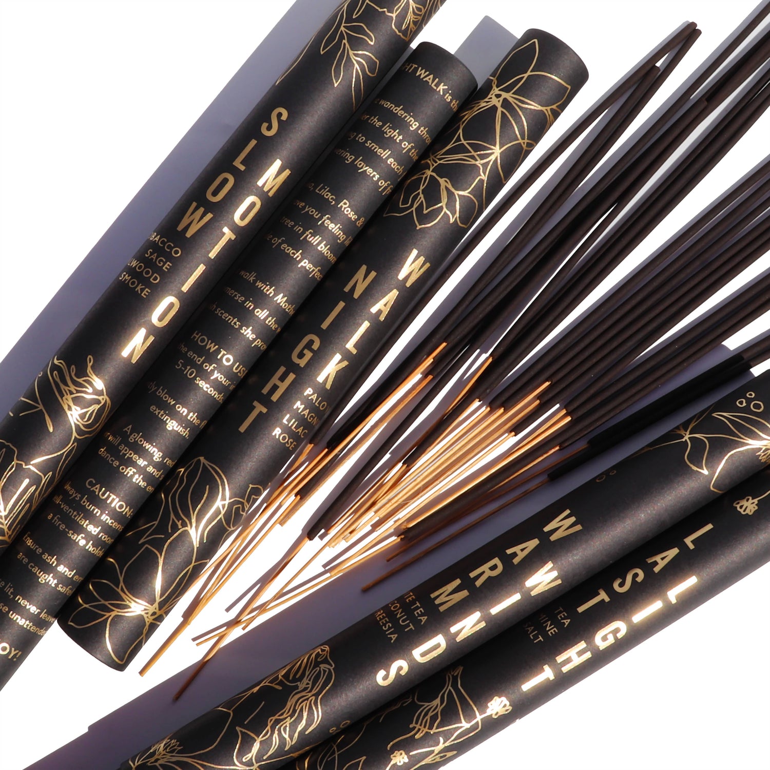 Set of makeup brushes with black handles and gold text on a white background