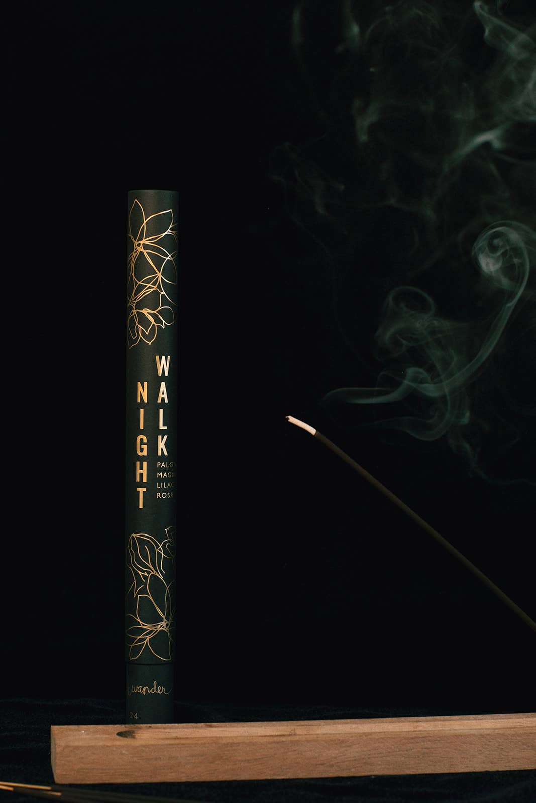 incense box 'Walk the Night' with incense burning on a dark background