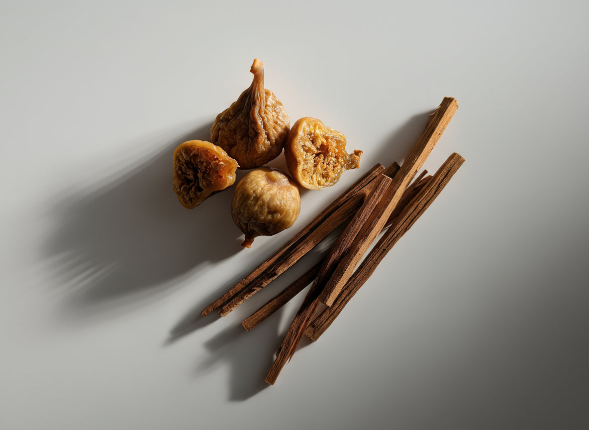 Figs and cinnamon sticks on a textured surface