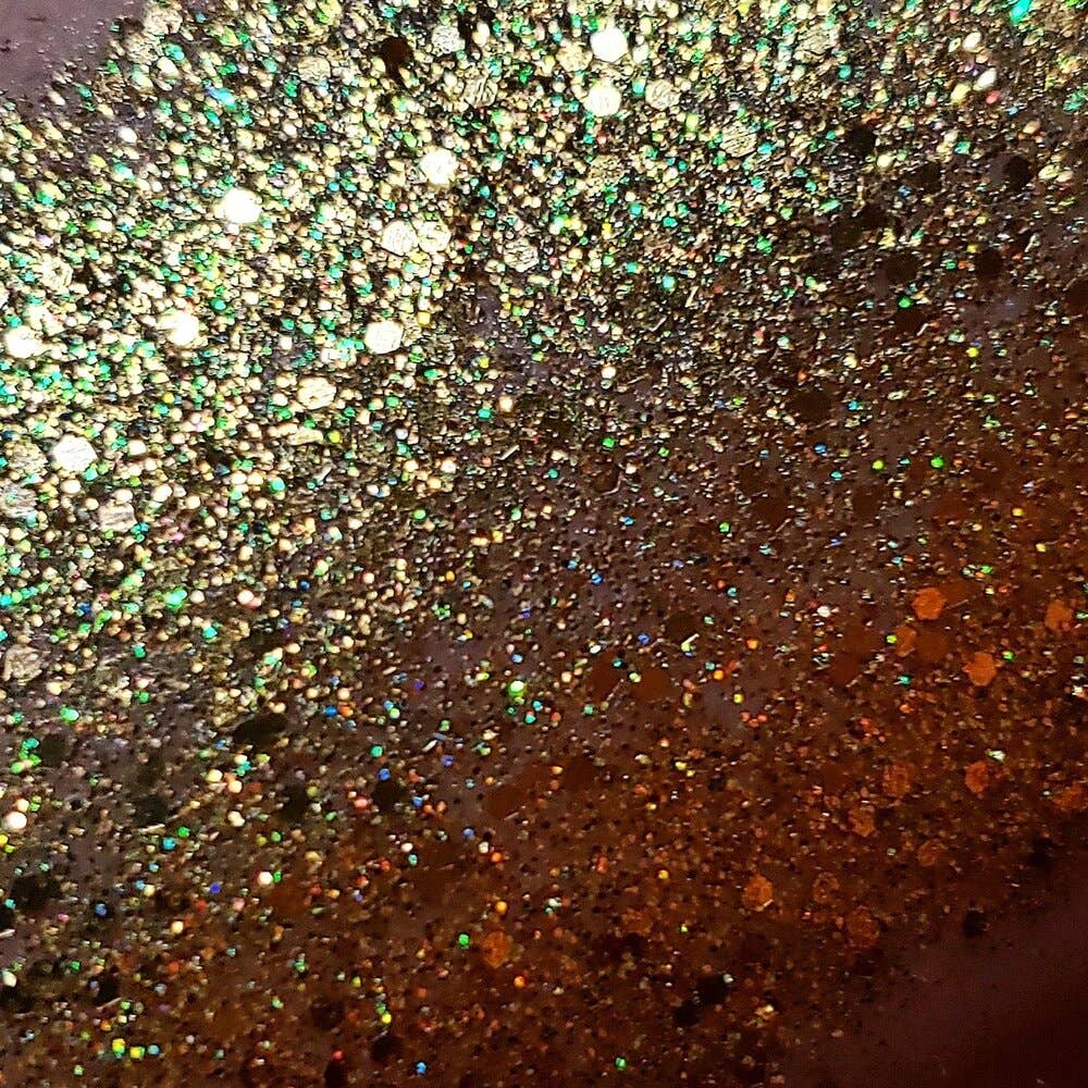 gold glitter spread on skin to show it shimmering