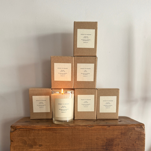 candles sitting on a wood shelf 