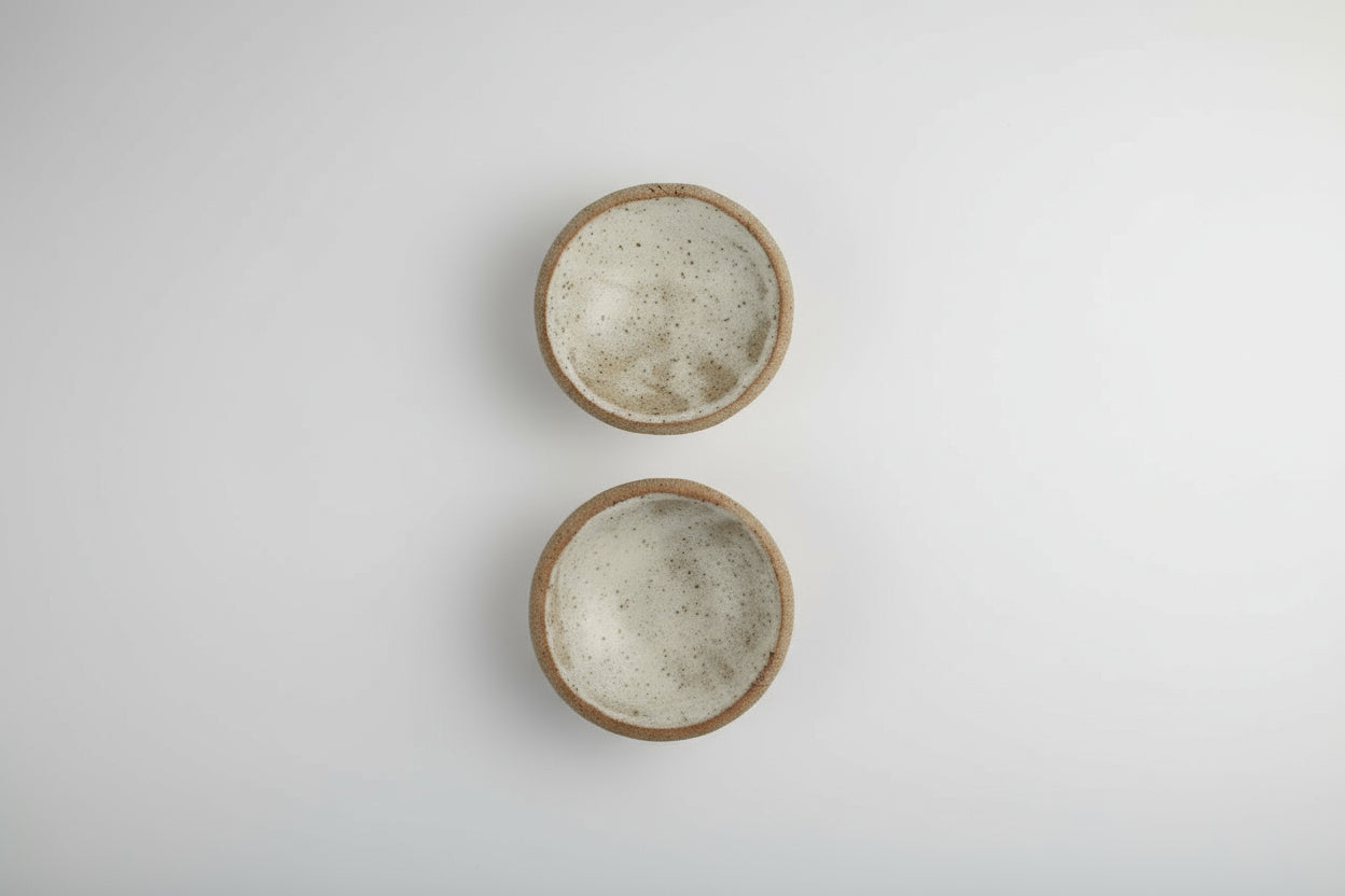 two 3" ceramic bowls sitting on a white background