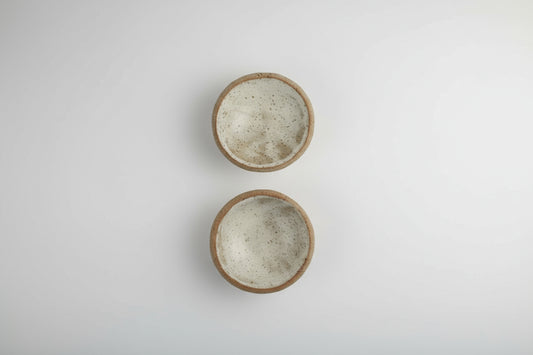 two 3" ceramic bowls sitting on a white background