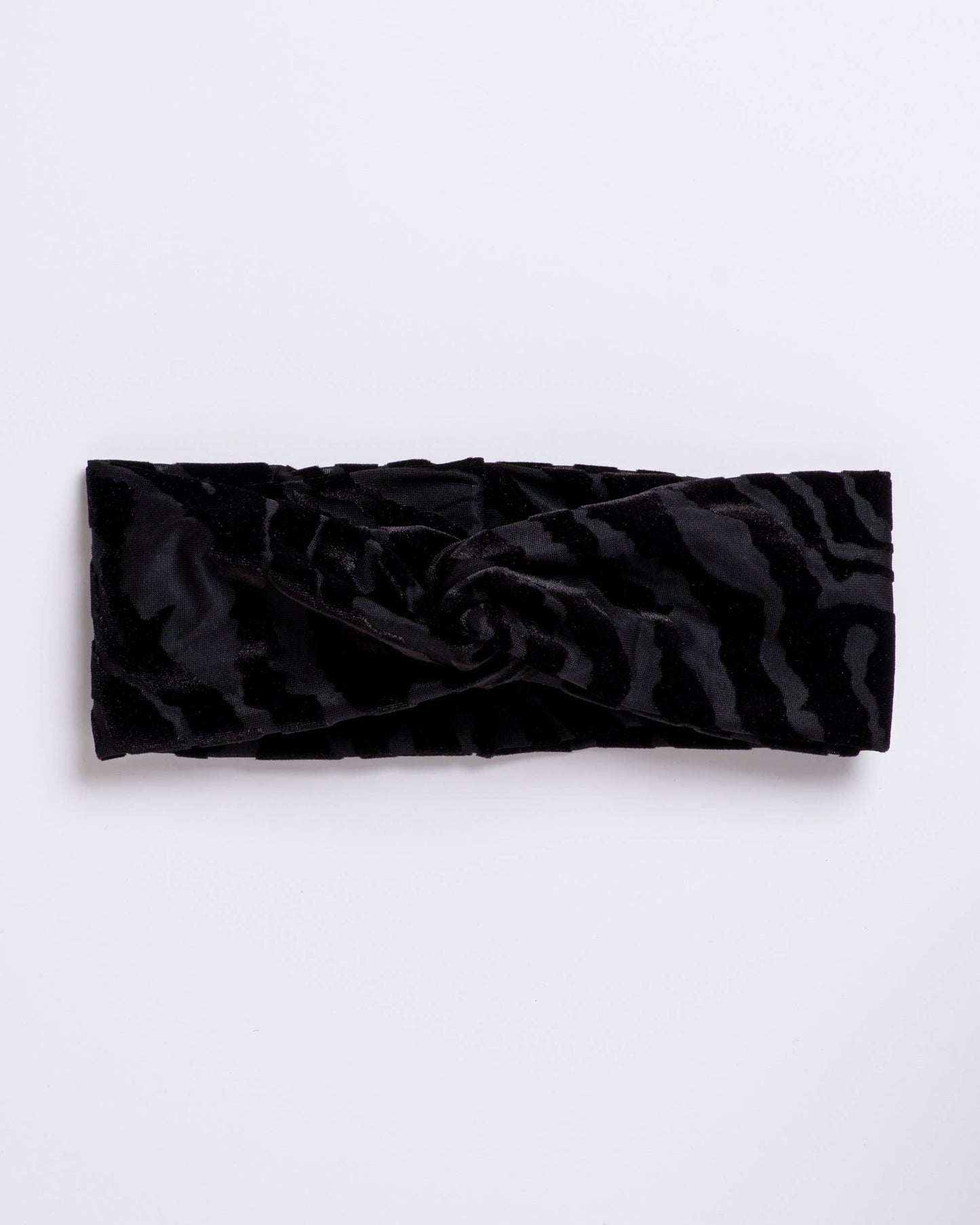 Black textured headband on a light gray background