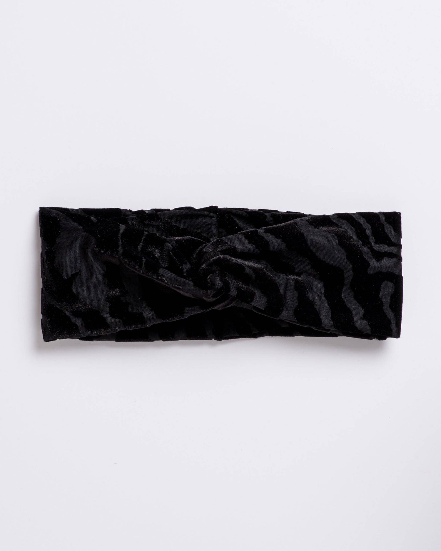 Black textured headband on a light gray background