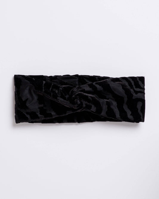 Black textured headband on a light gray background