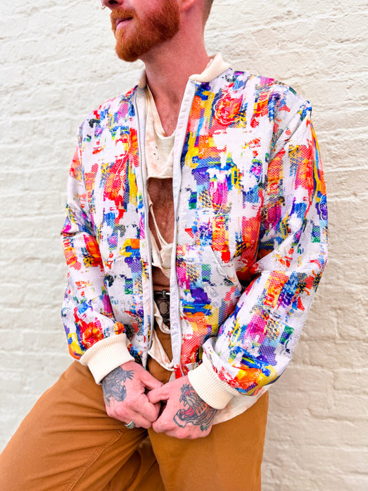 Person wearing a colorful jacket with a textured wall background