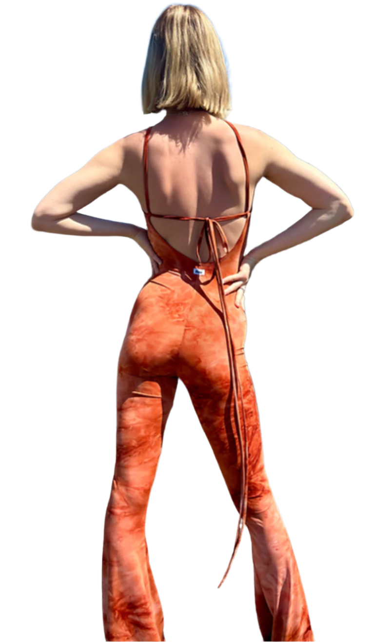 The back of a woman wearing an orange tie dye bell bottom jumpsuit