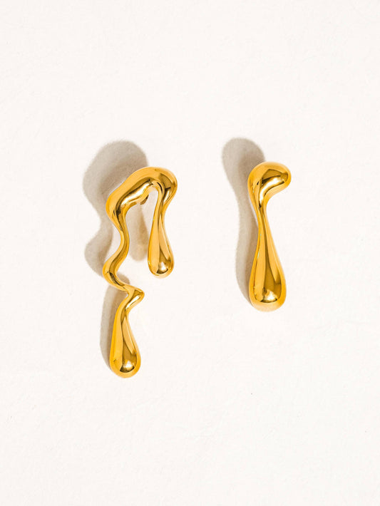 mismatch gold earrings on a white background