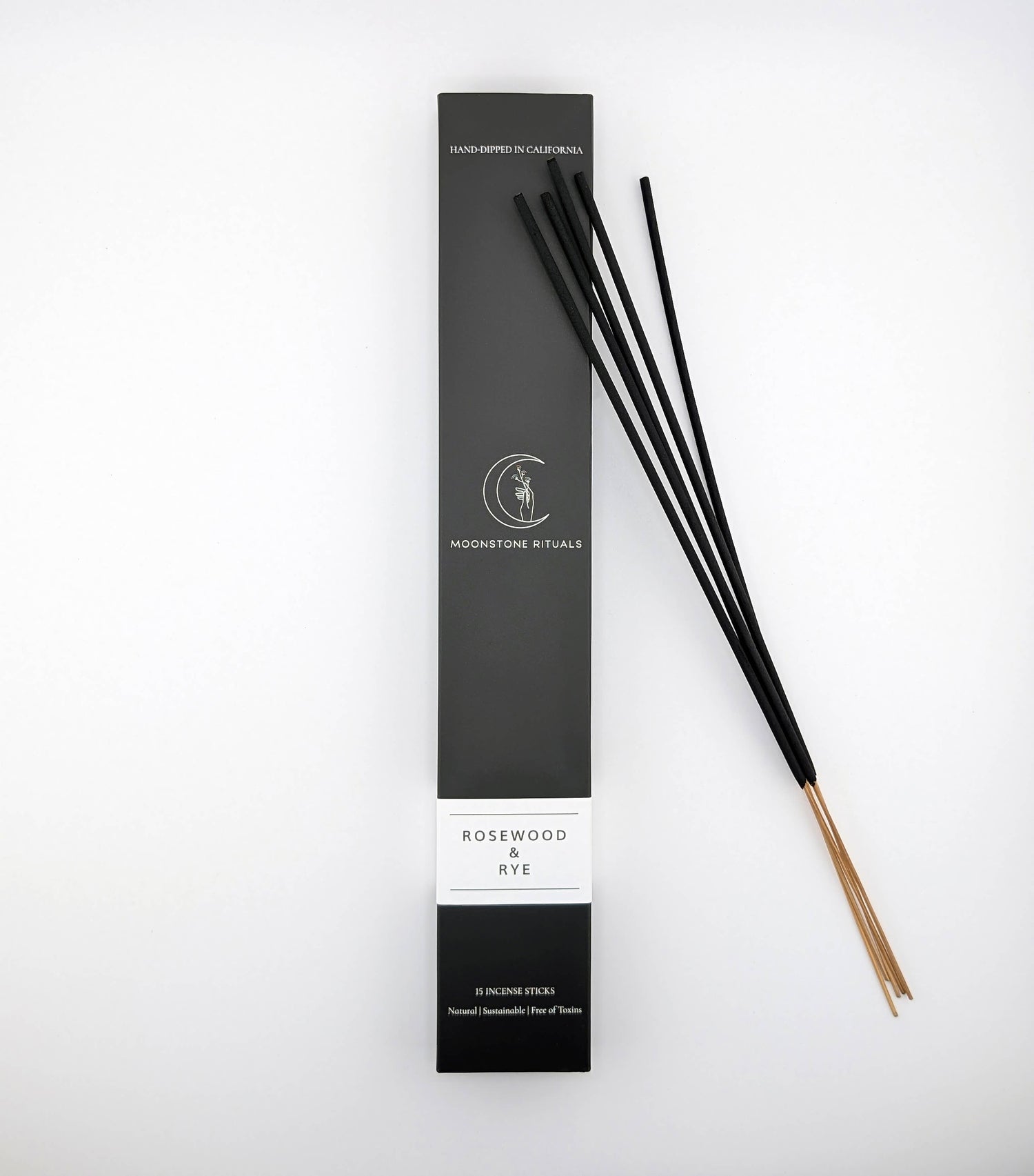 Black incense sticks with packaging on a white background