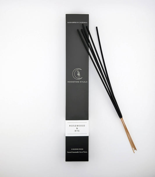 Black incense sticks with packaging on a white background