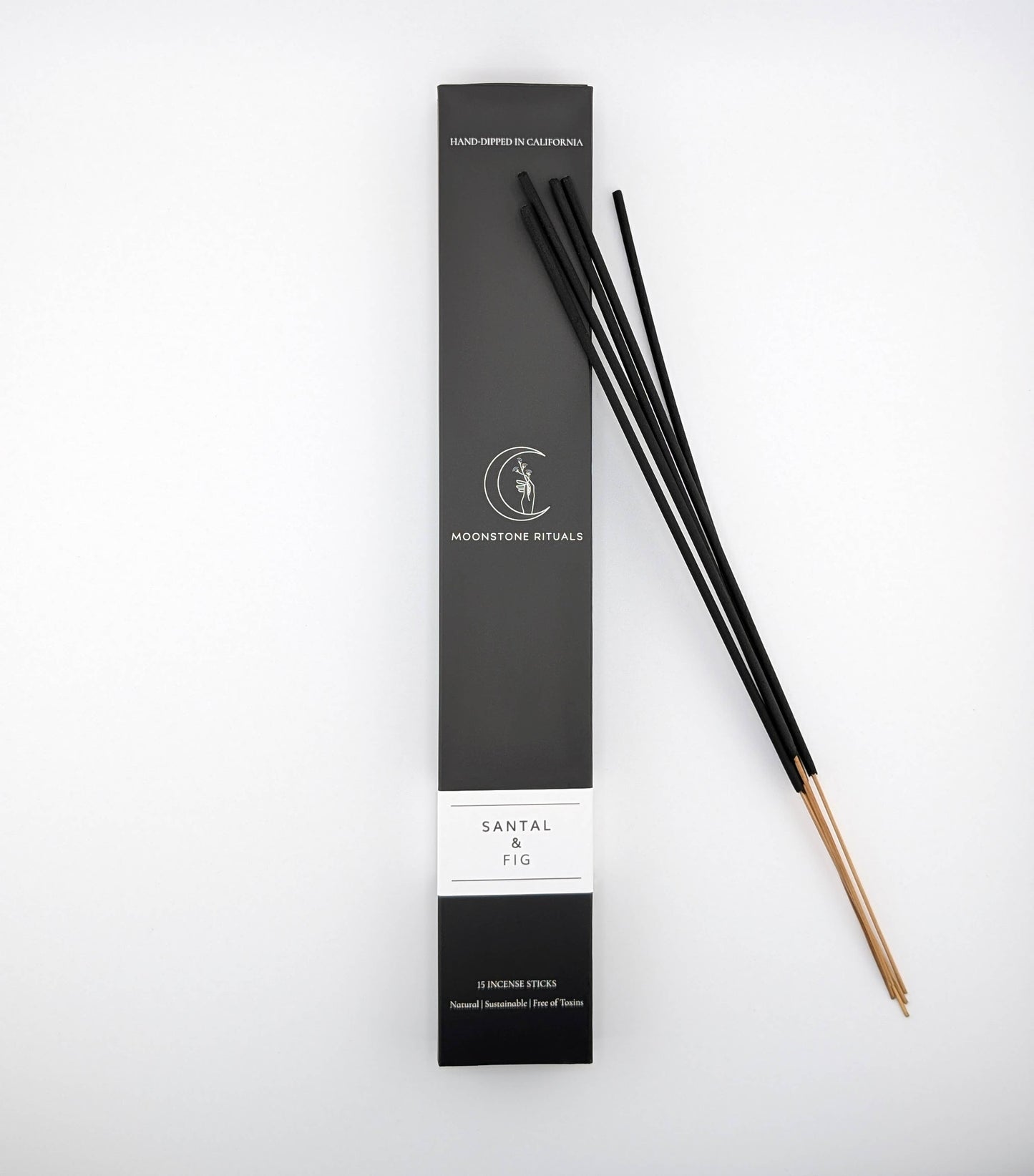 Black incense sticks with packaging on a white background
