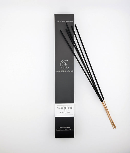 Black incense sticks with packaging labeled 'Smoked Oud & Vanilla' on a white background