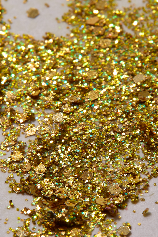 gold glitter spread out on a white background