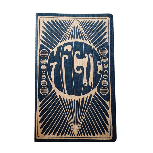 Black and gold notebook that says magic on the front cover