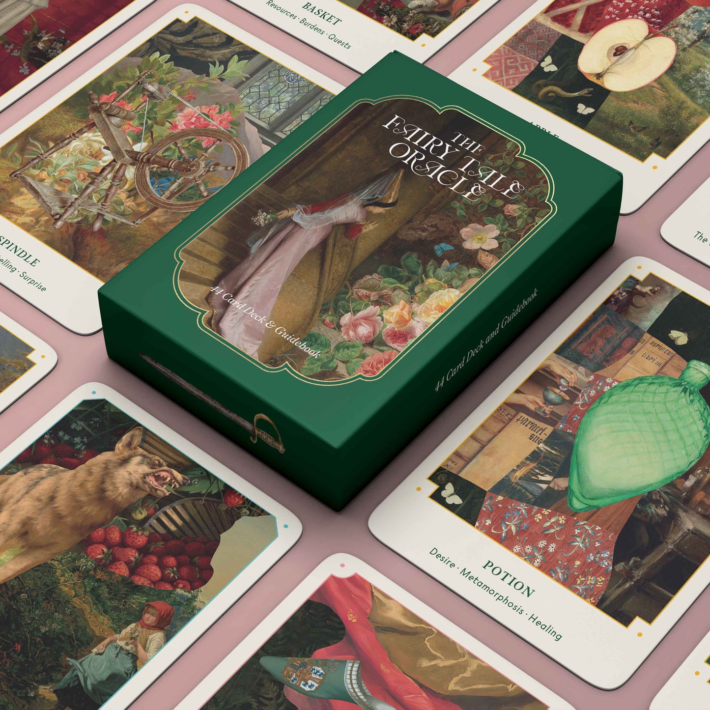 Fairy Tale Oracle card deck with green box on a pink surface with cards displayed.