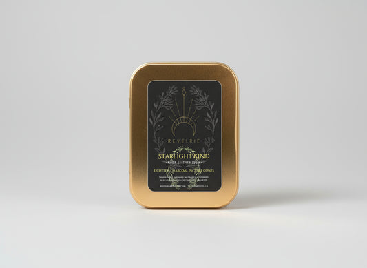 Gold tin with 'Revelrie' label on a dark background