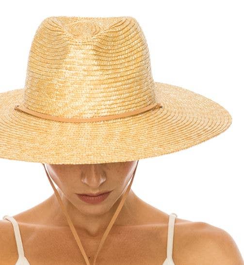 Woman wearing a straw hat on a white background